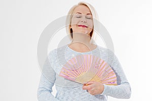 Beautiful middle aged woman with menopause blowing by fan. Hormone replacement therapy and mature woman healthcare. Mid age happy photo