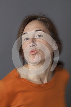 Beautiful middle aged woman pouting for seduction, love and happiness