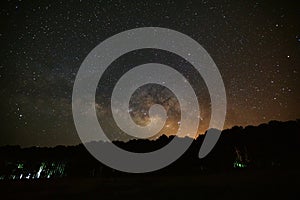 Beautiful milky way galaxy and silhouette of pine tree on a nigh