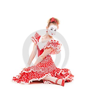 Beautiful mime in red dress sitting on the floor