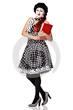 Beautiful mime in spotty dress holdingr red book