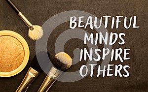 Beautiful minds inspire others. Text on notebook on a white background close-up