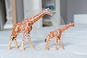 Beautiful miniature giraffes standing up made of rubber or plastic