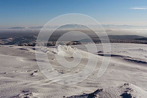 Beautiful minimalistic landscape of the hillside covered with white snow