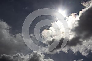 Beautiful miracle with clouds in the dark blue sky. Sun light. God light against background