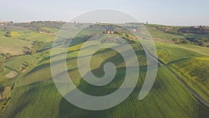 Beautiful and miraculous colors of green spring panorama landscape of Tuscany, Italy. Sunny morning near Pienza. Aerial view.