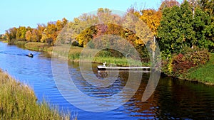 Beautiful Mississippi River with autumn foliage and a small fishing boat.
