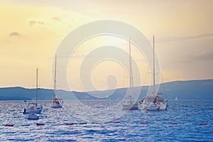 Beautiful misty Mediterranean sunset  with boats on water. Montenegro,  Kotor Bay