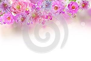 Beautiful mix of roses,orchid and dahlia flower frame in pink background with copy space
