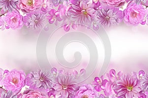 Beautiful mix of roses,orchid and dahlia flower frame in pink background with copy space