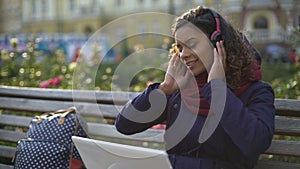 Beautiful mixed race girl enjoying listening to beloved music recordings outdoor