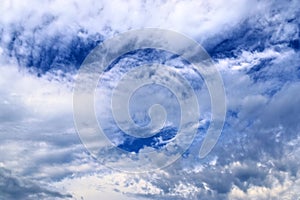 Beautiful mixed white and dark cloud formations on a blue sky