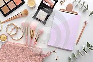 Beautiful mockup flat lay design for blogging workplace background. Cosmetics, makeup brushes, cosmetic bag, palette