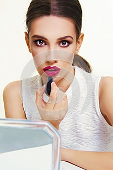 Beautiful model applying make up