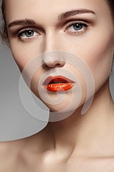 Beautiful model with bright red lips make-up, pure skin