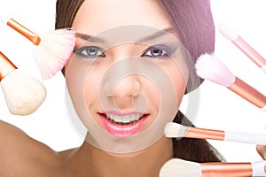 Beautiful model face with make-up brushes