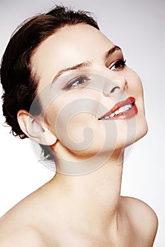 Beautiful model with fashion make-up. Close-up portrait woman with glamour lip gloss makeup and bright eye shadows.