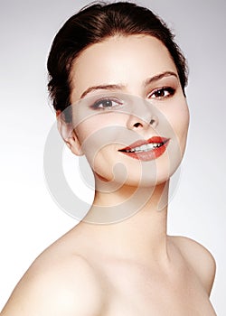 Beautiful model with fashion make-up. Close-up portrait woman with glamour lip gloss makeup and bright eye shadows.