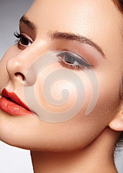 Beautiful model with fashion make-up. Close-up portrait woman with glamour lip gloss makeup and bright eye shadows.