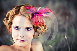 Beautiful model with feather in hair