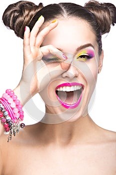 Beautiful model girl with bright colored makeup and nail polish in the summer image. Beauty face. Short colored nails.