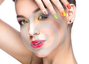 Beautiful model girl with bright colored makeup and nail polish in the summer image. Beauty face. Short colored nails.