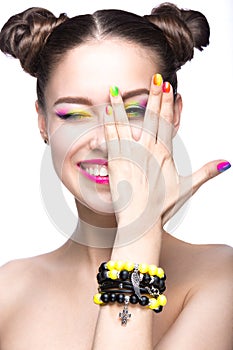 Beautiful model girl with bright colored makeup and nail polish in the summer image. Beauty face. Short colored nails.