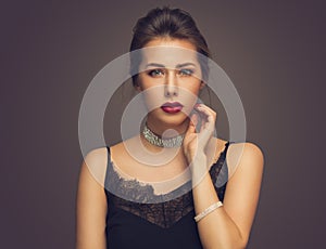 Beautiful model girl with elegant hairstyle . Woman with red lips and nails . Cosmetics, beauty and manicure on nails.