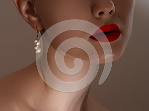 Beautiful model girl with pearl earrings . Fashion makeup and cosmetics . Big earrings and gold ring jewelry