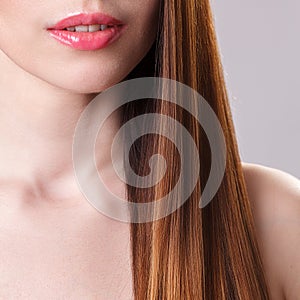 Beautiful model girl with shiny brown straight long hair . Care and hair products