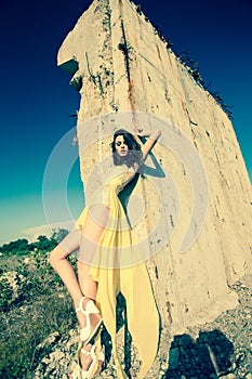 Beautiful model in green dress posing in grunge location