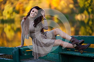 Beautiful model by the lake surrounded by forest with reflection