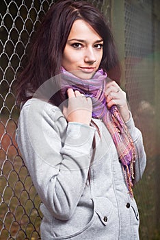 Beautiful model leaning to fence