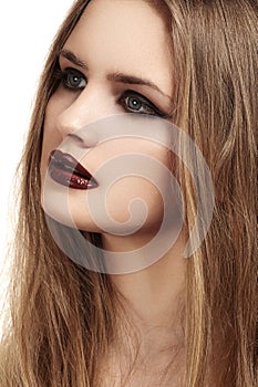 Beautiful model with long hair & grunge dark gloss lips make-up, black liner
