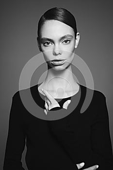 Beautiful model pose in studio in evening clothes. Classic black dress