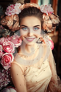 Beautiful model is posing with creative makeup and flowers