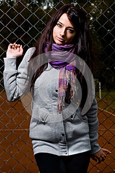 Beautiful model with tennis court behind her