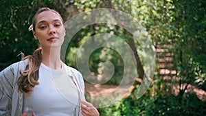 Beautiful model walking forest smiling gently closeup. Cute woman strolling park