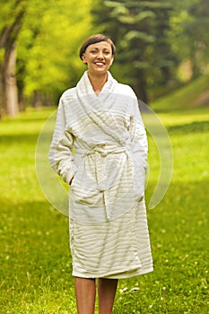 A beautiful model wearing a white toweling robe standing