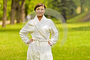A beautiful model wearing a white toweling robe standing