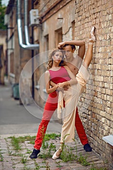 Beautiful modern ballet couple dancing in summer outdoors