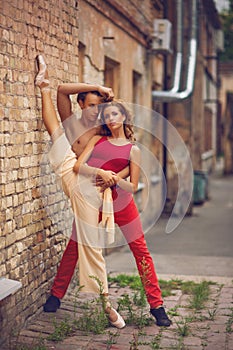 Beautiful modern ballet couple dancing in summer outdoors