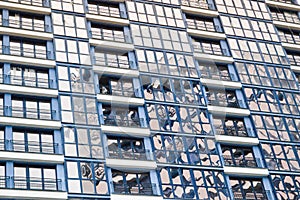 Beautiful modern blue glass fiberglass windows of the facade wall of a modern skyscraper building house. Background, texture