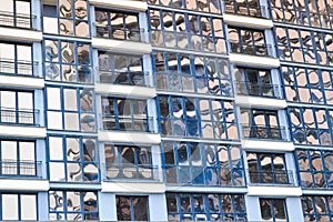 Beautiful modern blue glass fiberglass windows of the facade wall of a modern skyscraper building house. Background, texture