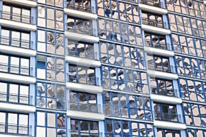 Beautiful modern blue glass fiberglass windows of the facade wall of a modern skyscraper building house. Background, texture