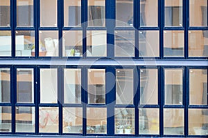 Beautiful modern blue glass fiberglass windows of the facade wall of a modern skyscraper building house. Background, texture