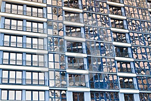 Beautiful modern blue glass fiberglass windows of the facade wall of a modern skyscraper building house. Background, texture