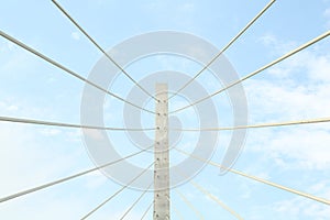 Beautiful modern bridge against blue cloudy sky, low angle view photo