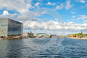 Beautiful modern buildings on the bank of the canal in Copenhagen, Denmark. Beautiful clouds. Contemporary European architecture.