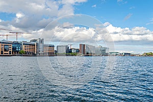 Beautiful modern buildings on the bank of the canal in Copenhagen, Denmark.Sun, beautiful clouds. Contemporary European